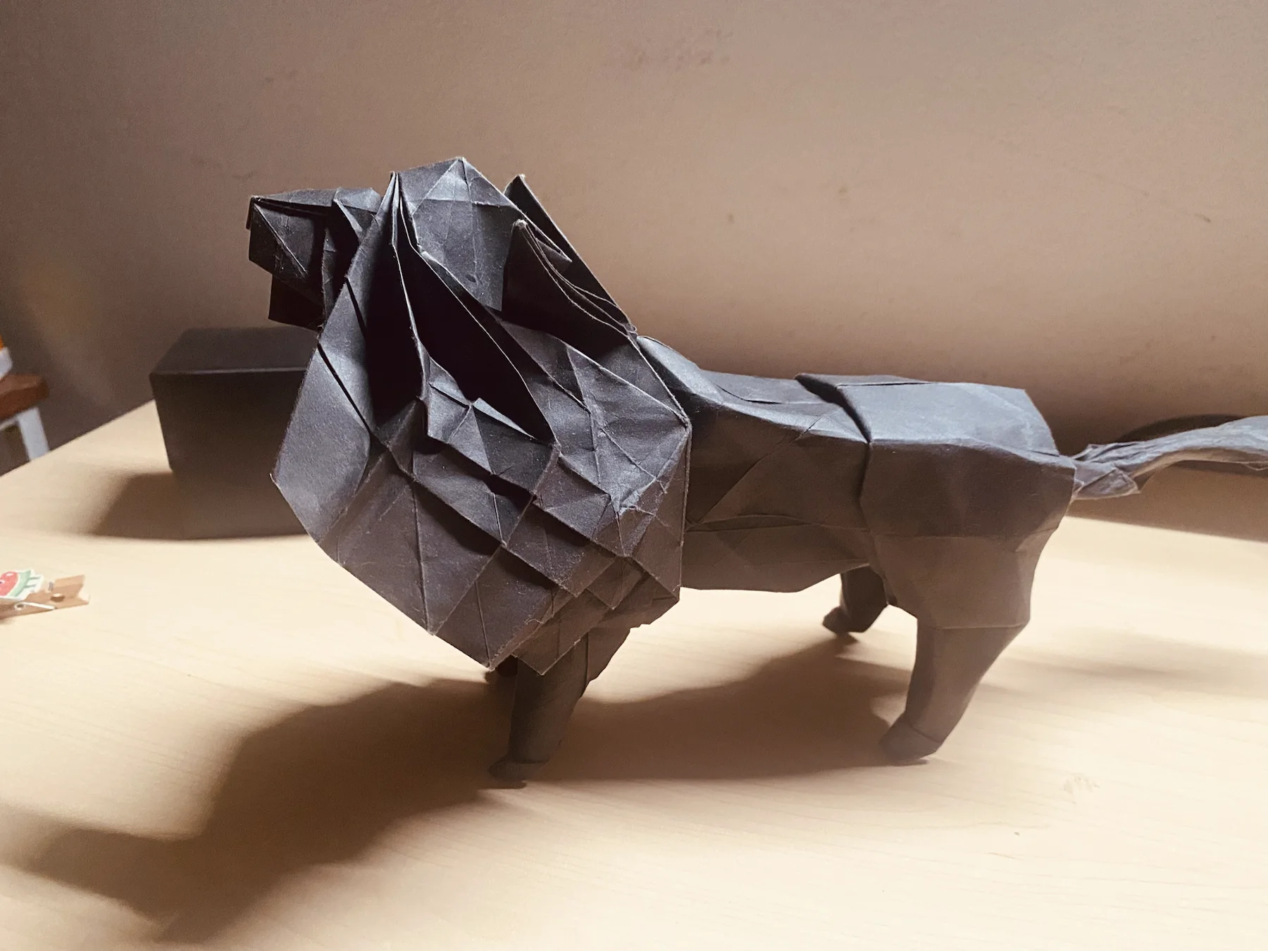 Dark paper origami lion